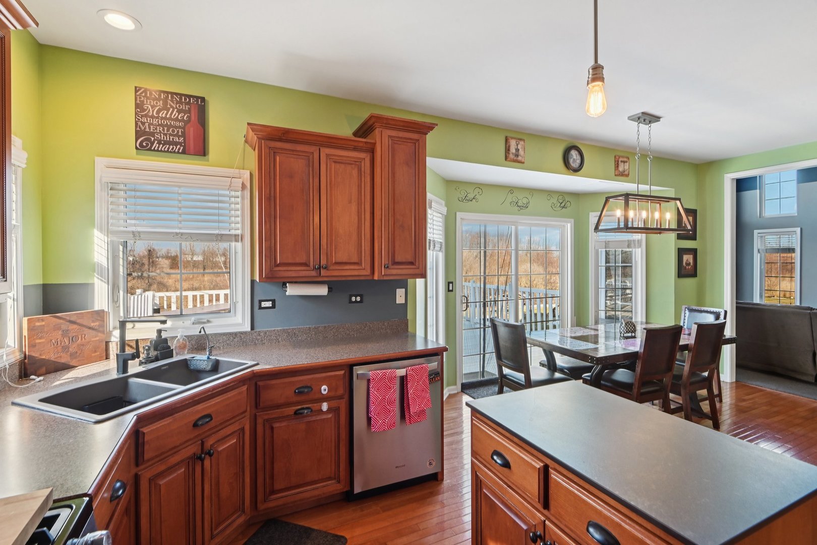 16385 Celtic Circle Manhattan, IL 60442 - Photo 13 of 49 a kitchen with stainless steel appliances granite countertop a sink a stove and a refrigerator