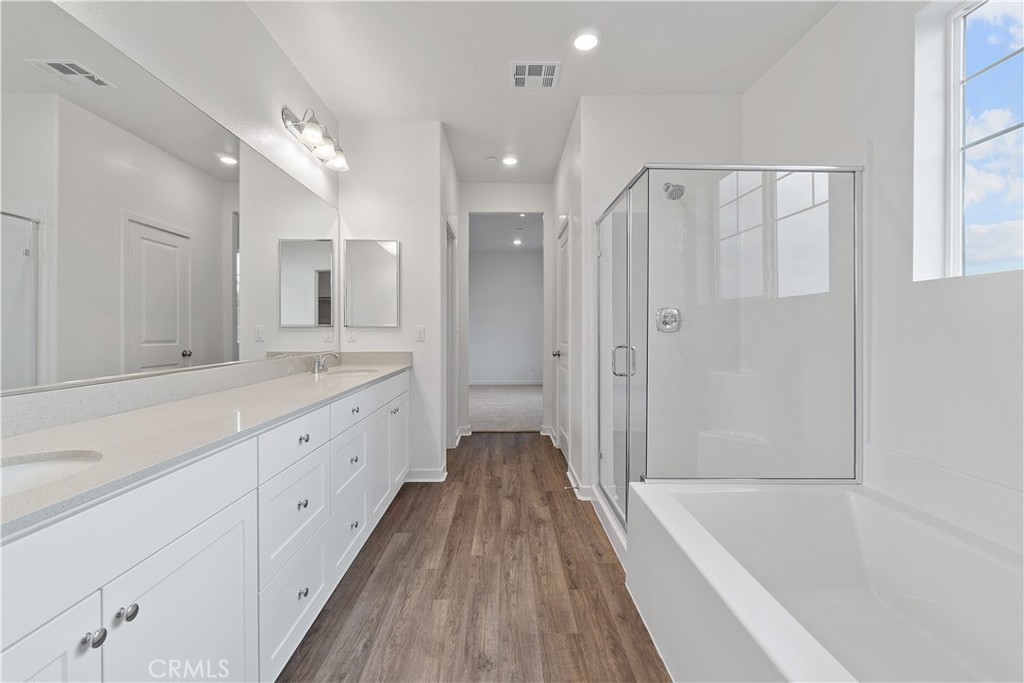 12764 Clifton Way Yucaipa, CA 92399 - Photo 13 of 24 a spacious bathroom with a granite countertop tub shower double vanity and a mirror