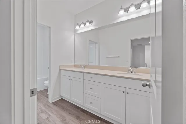 a bathroom with a double vanity sink and a mirror