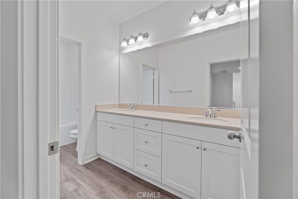 12764 Clifton Way Yucaipa, CA 92399 - Photo 16 of 24 a bathroom with a double vanity sink and a mirror