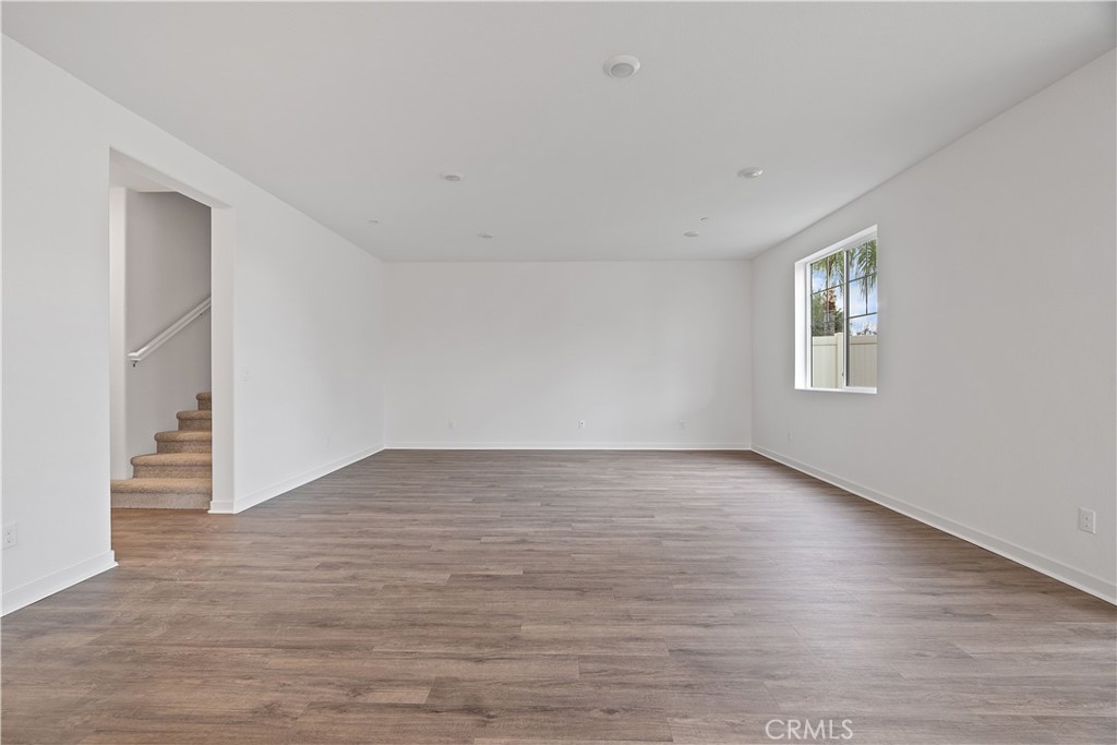 12764 Clifton Way Yucaipa, CA 92399 - Photo 3 of 24 a view of an empty room with wooden floor and a window
