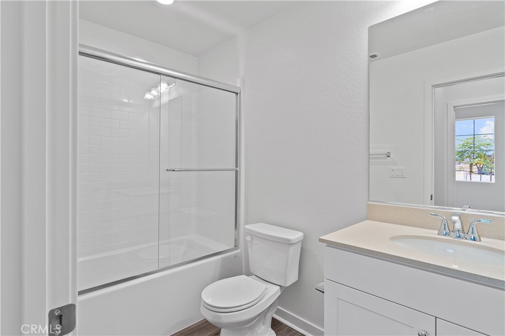 12764 Clifton Way Yucaipa, CA 92399 - Photo 8 of 24 a bathroom with a granite countertop sink toilet and shower