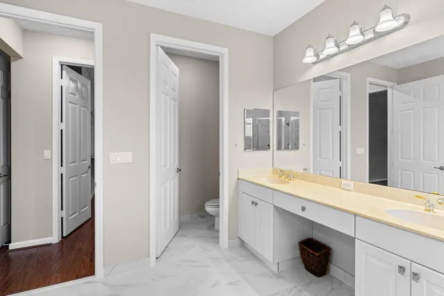 a bathroom with a double vanity sink mirror and double