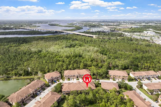 an aerial view of a city with lots of residential buildings lake and ocean view