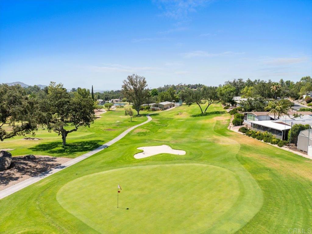 18218 Paradise Mountain Road, Unit 116 Valley Center, CA 92082 - Photo 27 of 35 a view of a big yard with swimming pool and green space