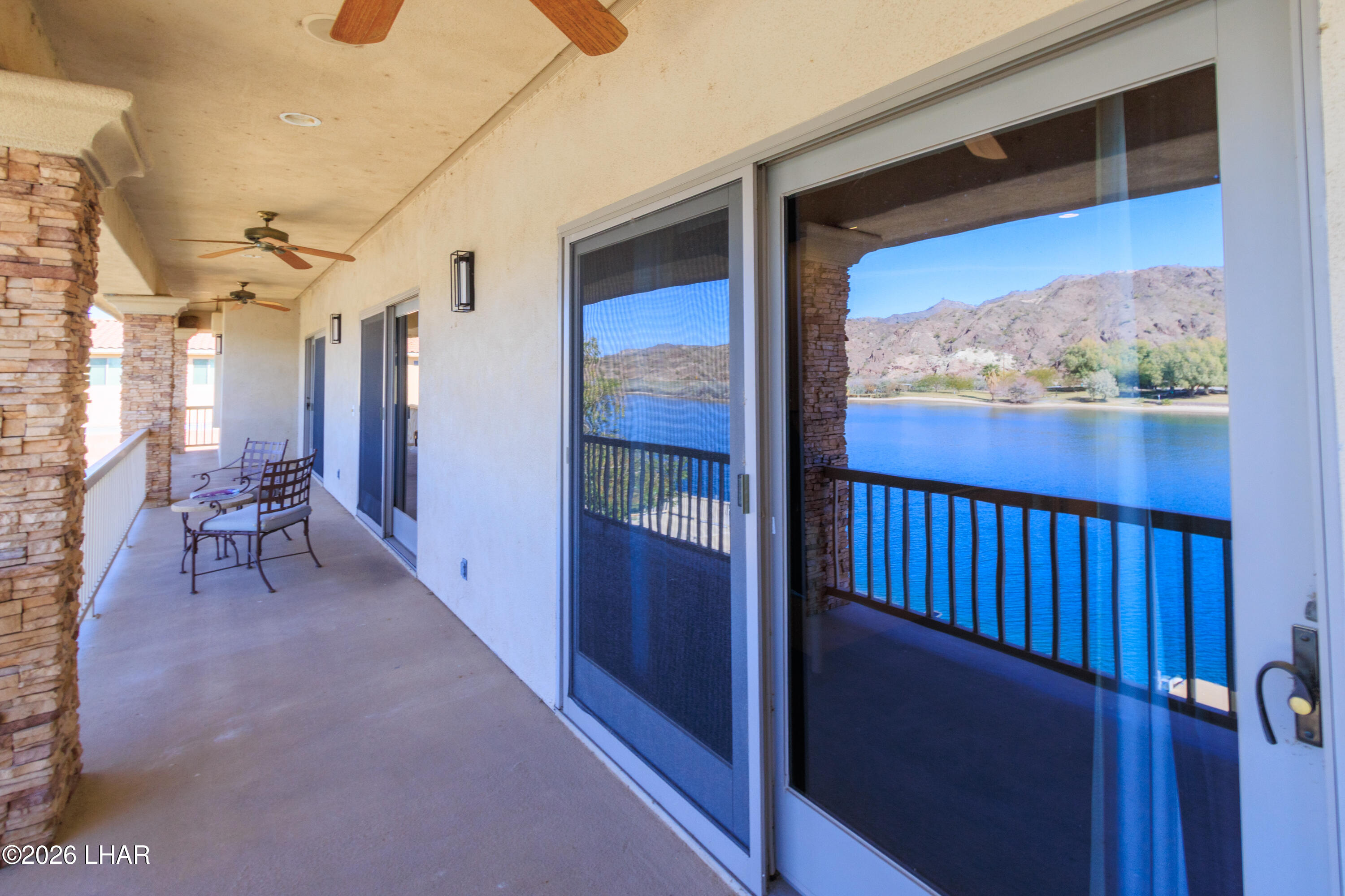 6674 Riverside Drive Parker, AZ 85344 - Photo 18 of 57 a view of a porch with a table and chairs