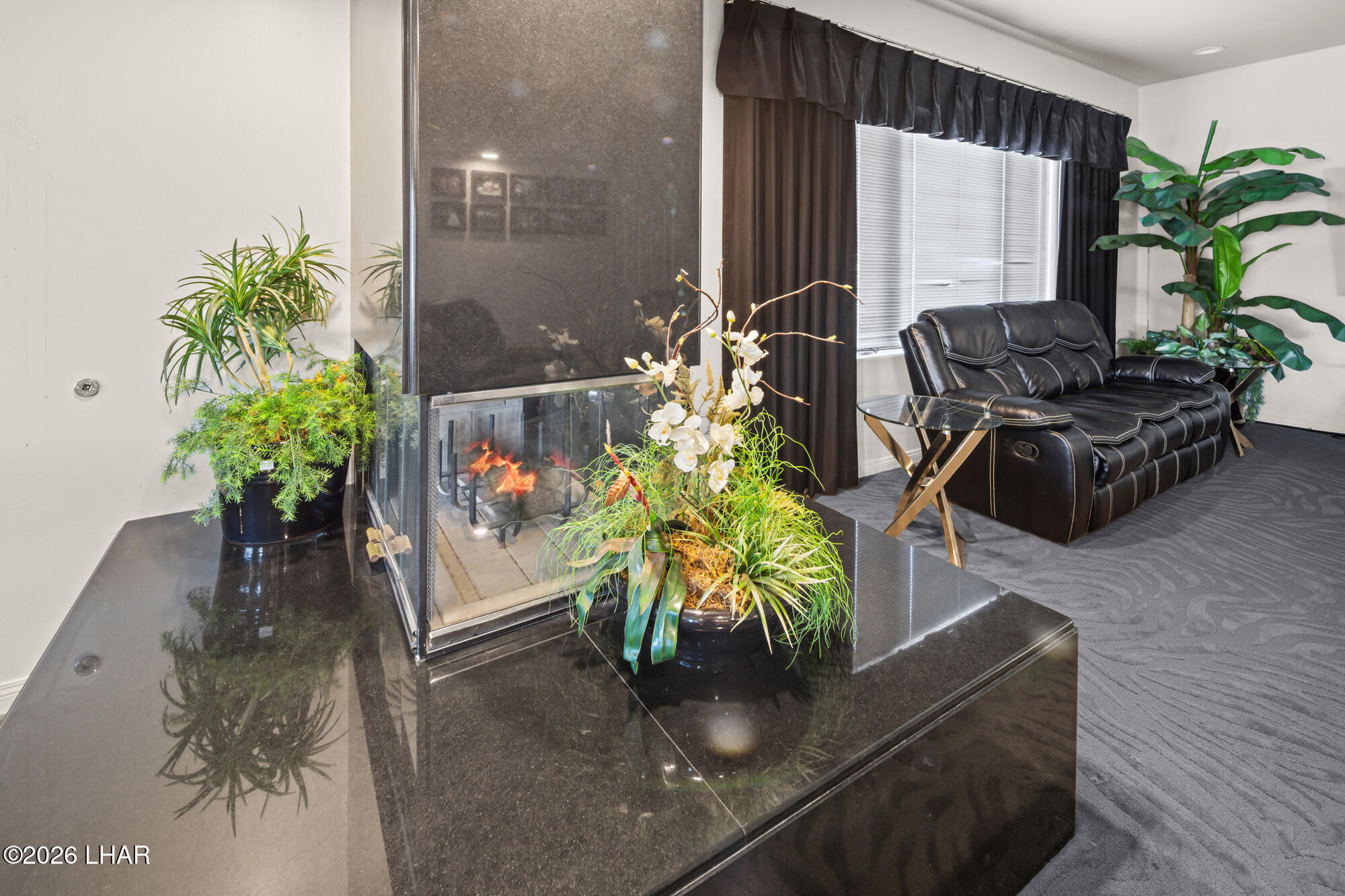 6674 Riverside Drive Parker, AZ 85344 - Photo 24 of 57 a vase of flowers sitting on a table in a lobby