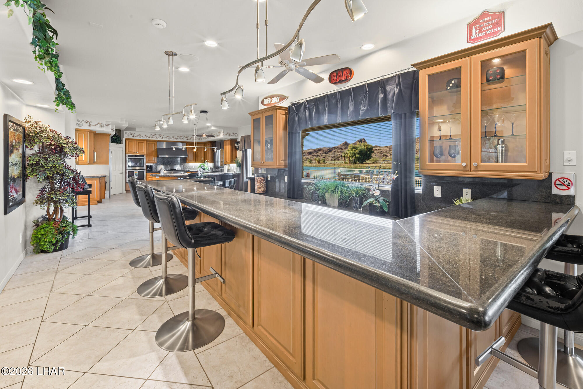6674 Riverside Drive Parker, AZ 85344 - Photo 28 of 57 a kitchen with stainless steel appliances granite countertop a stove a sink and a microwave