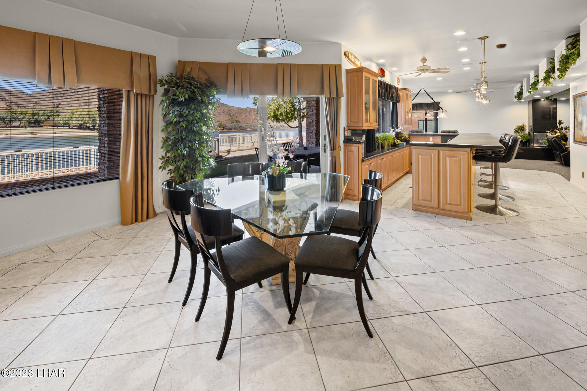 6674 Riverside Drive Parker, AZ 85344 - Photo 32 of 57 a view of a dining room with furniture a chandelier and kitchen view