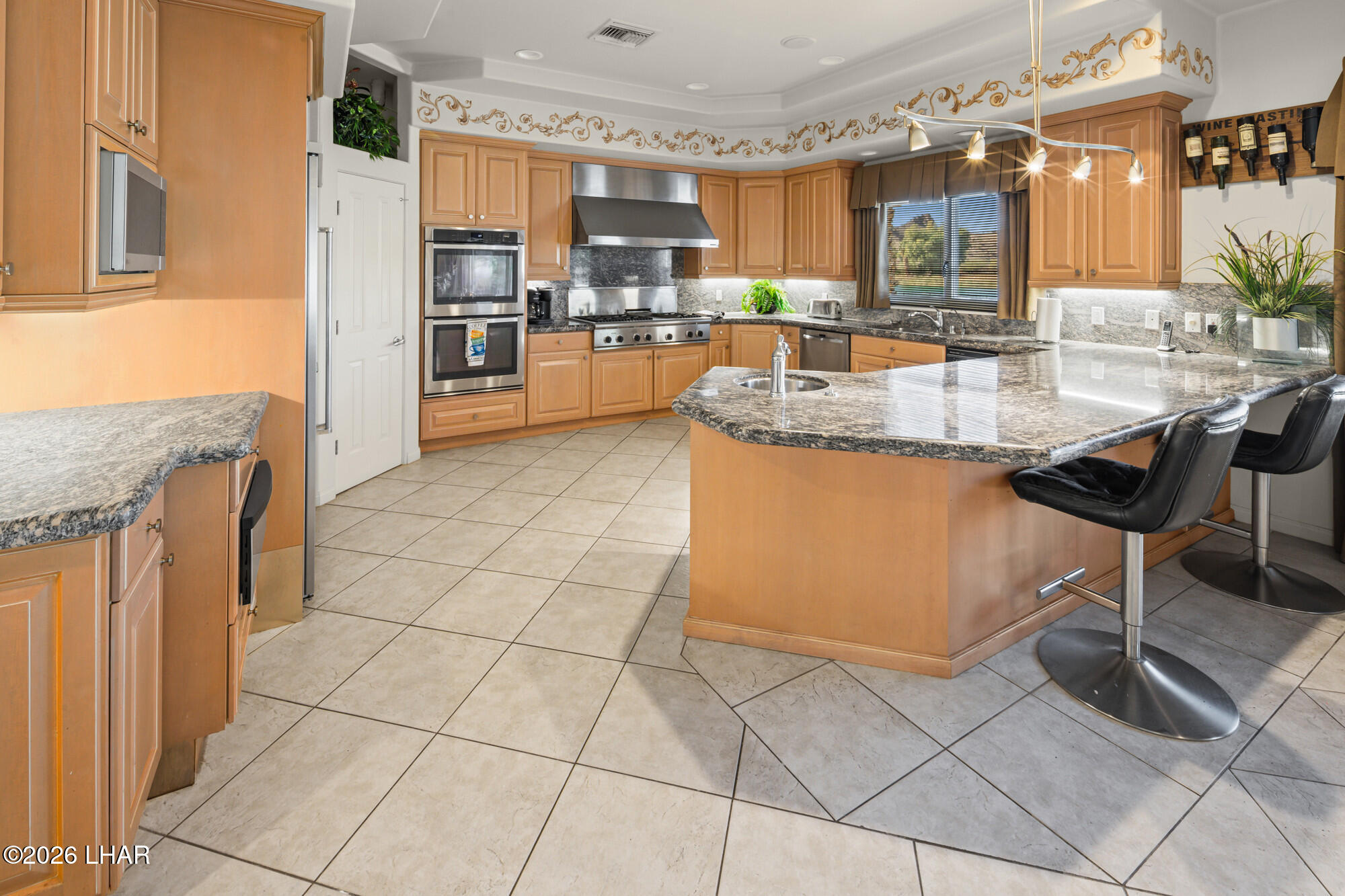 6674 Riverside Drive Parker, AZ 85344 - Photo 33 of 57 a kitchen with granite countertop a stove a sink and a refrigerator