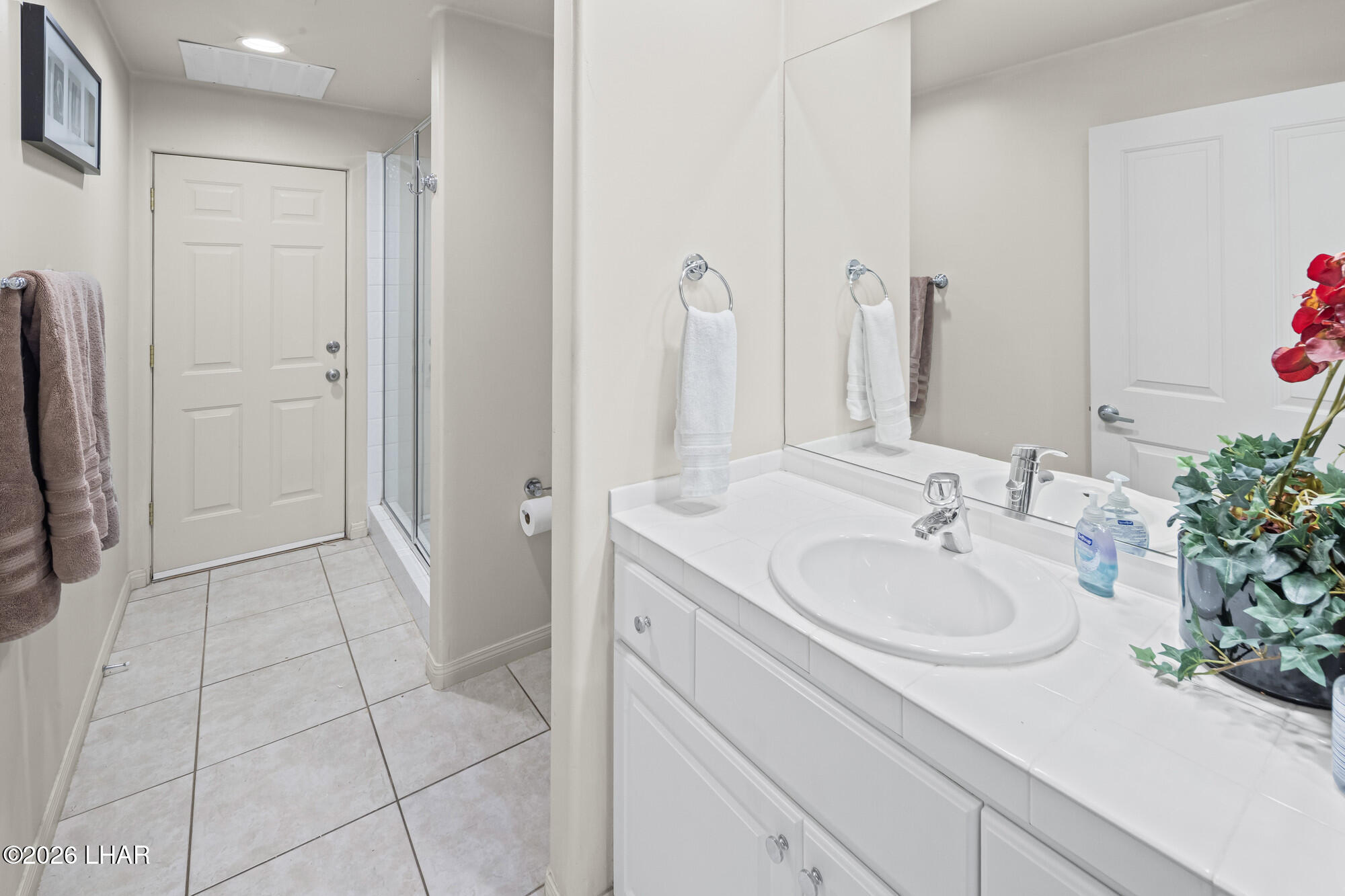 6674 Riverside Drive Parker, AZ 85344 - Photo 36 of 57 a bathroom with a sink a mirror and a shower