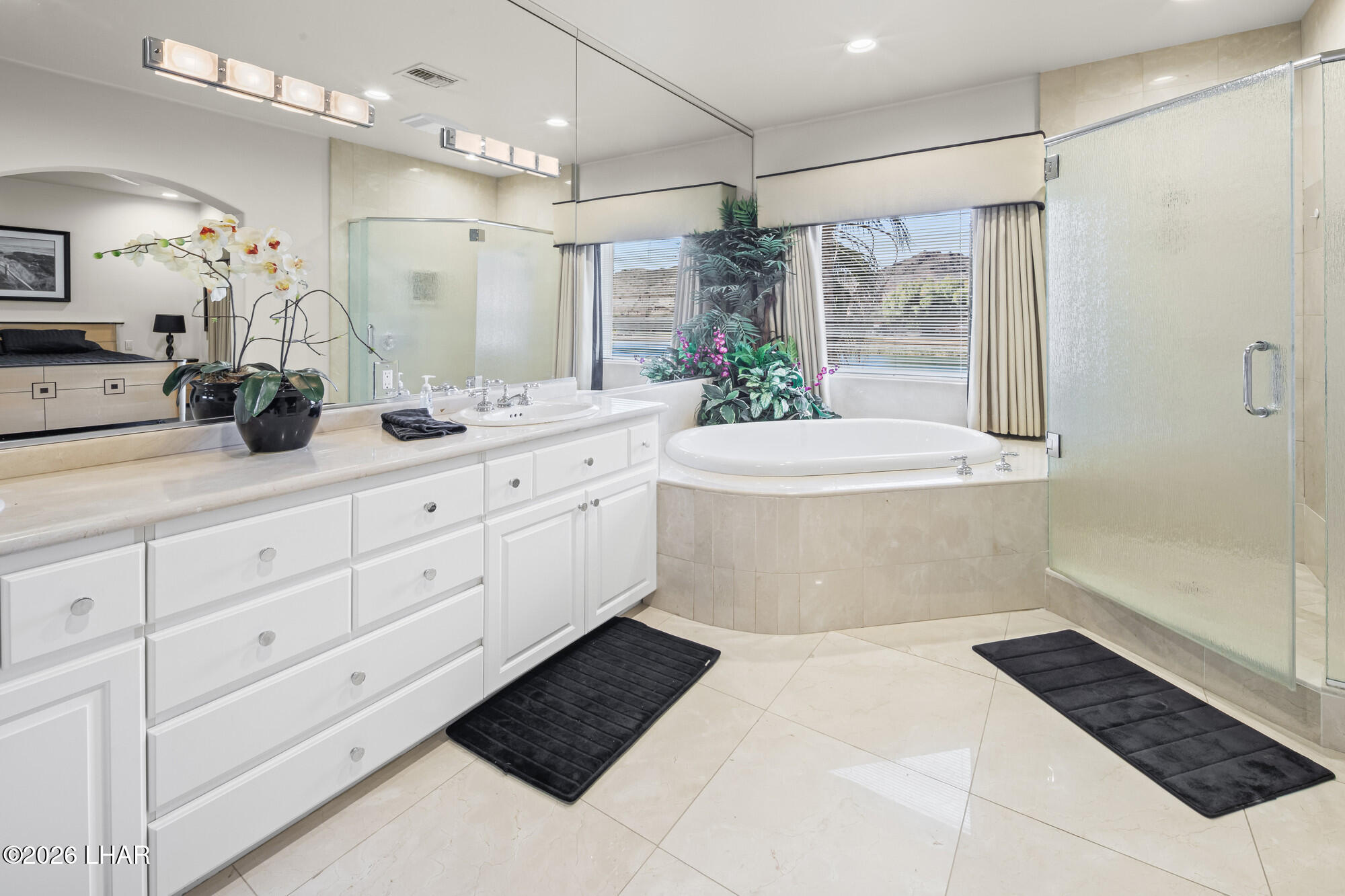 6674 Riverside Drive Parker, AZ 85344 - Photo 44 of 57 a large white bathroom with a large tub a double vanity sink and shower