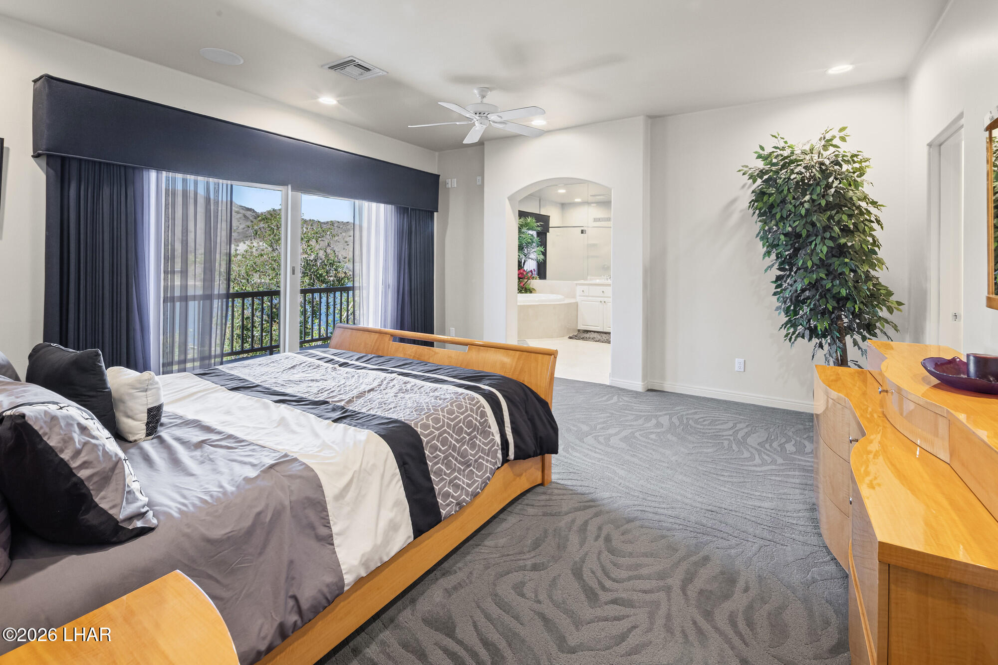 6674 Riverside Drive Parker, AZ 85344 - Photo 46 of 57 a bed sitting in a spacious bedroom next to a window