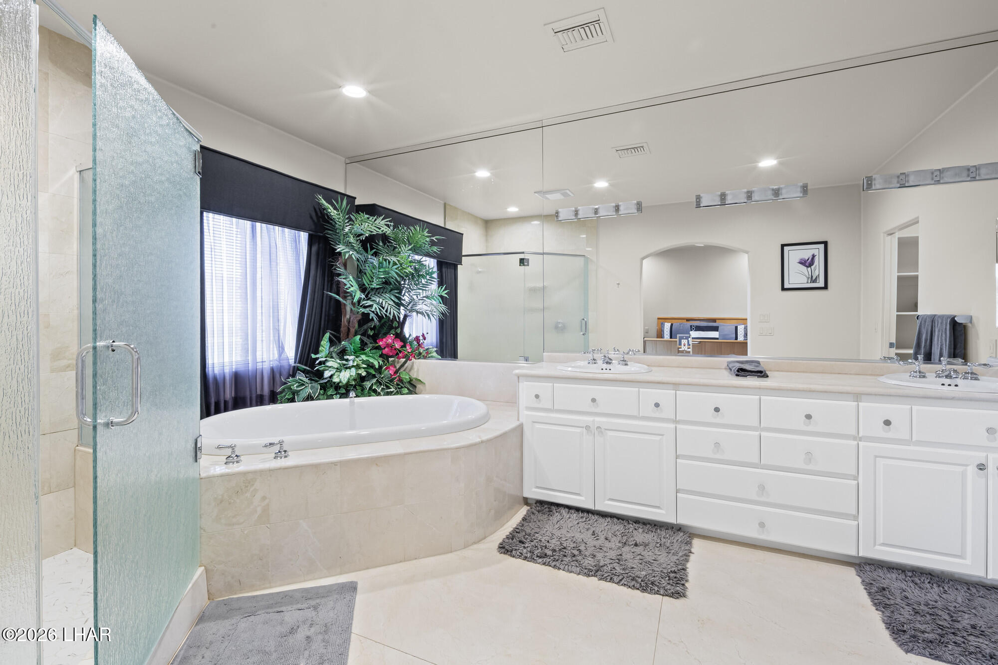 6674 Riverside Drive Parker, AZ 85344 - Photo 49 of 57 a bathroom with a sink a large mirror and a toilet
