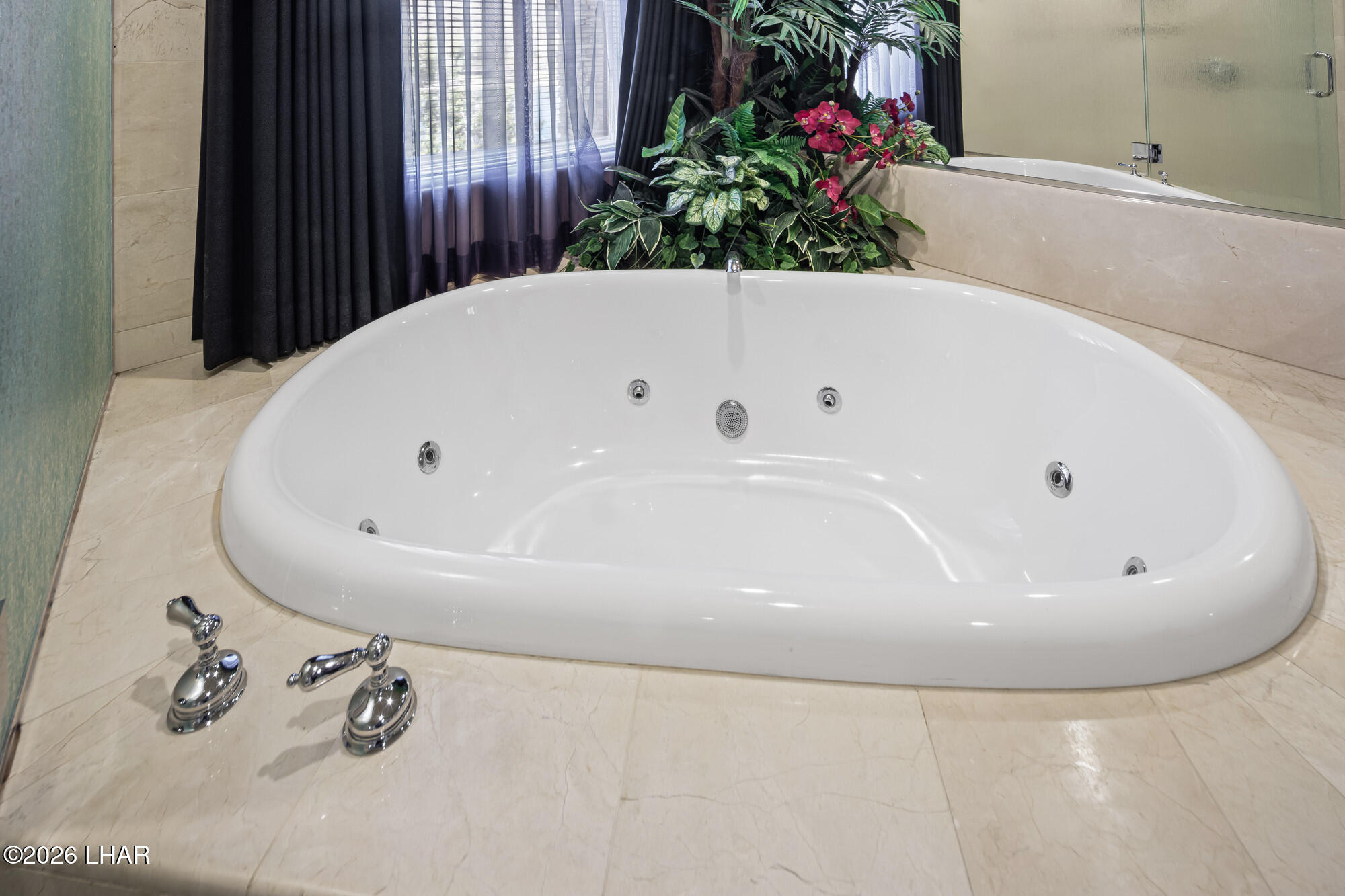 6674 Riverside Drive Parker, AZ 85344 - Photo 50 of 57 a bathroom with a tub and flowers