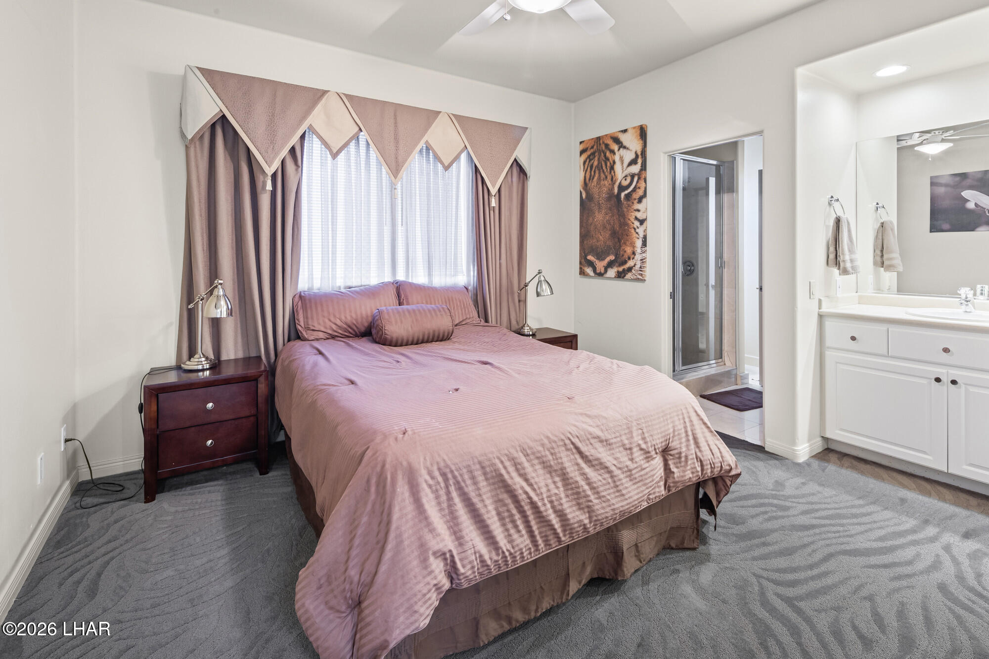 6674 Riverside Drive Parker, AZ 85344 - Photo 53 of 57 a bedroom with a bed and a large mirror