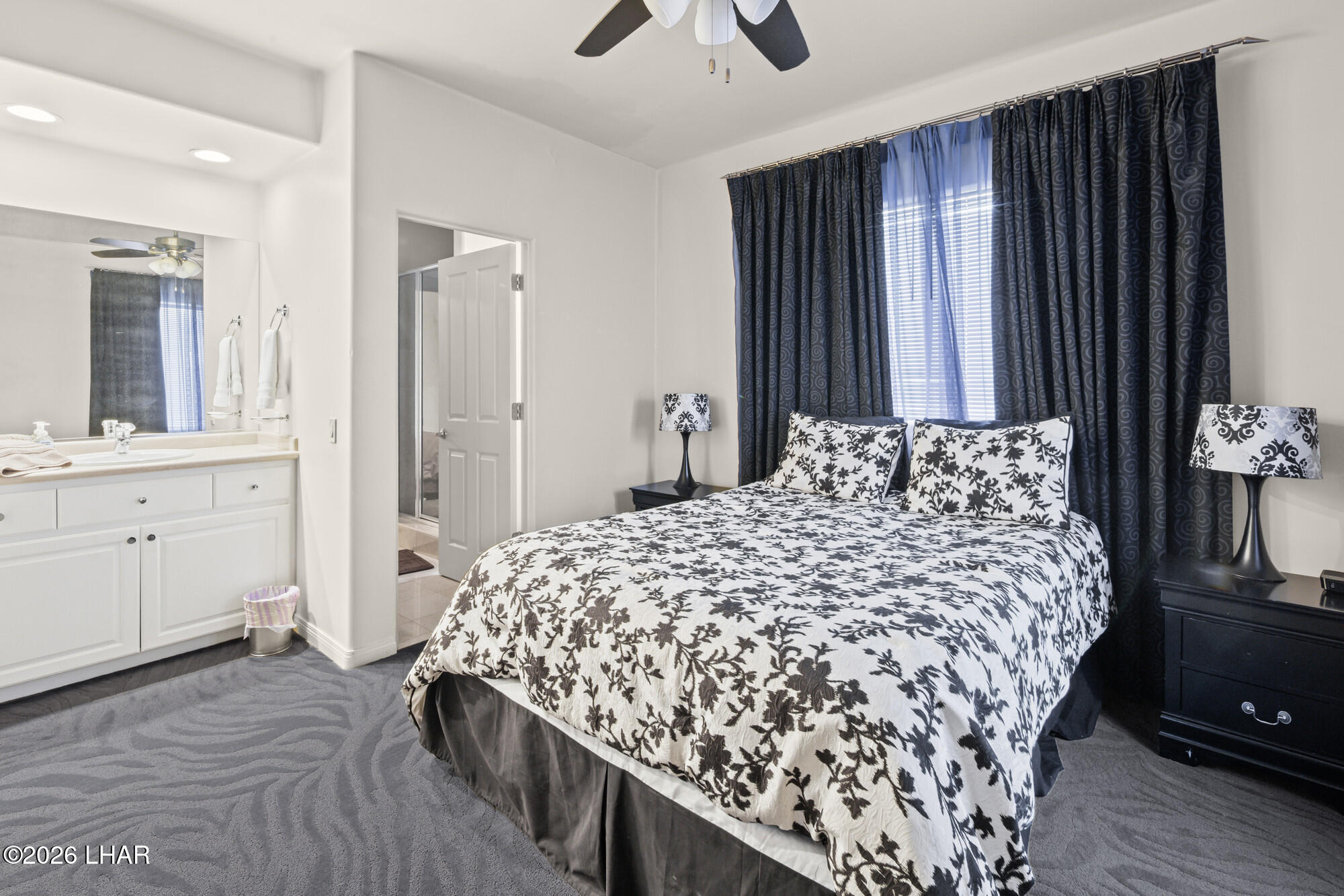 6674 Riverside Drive Parker, AZ 85344 - Photo 57 of 57 a bedroom with a bed and a chandelier