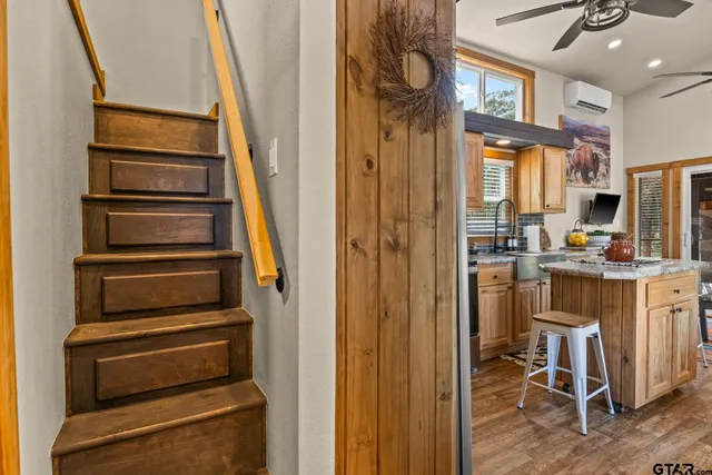 a view of kitchen with sink and refrigerator