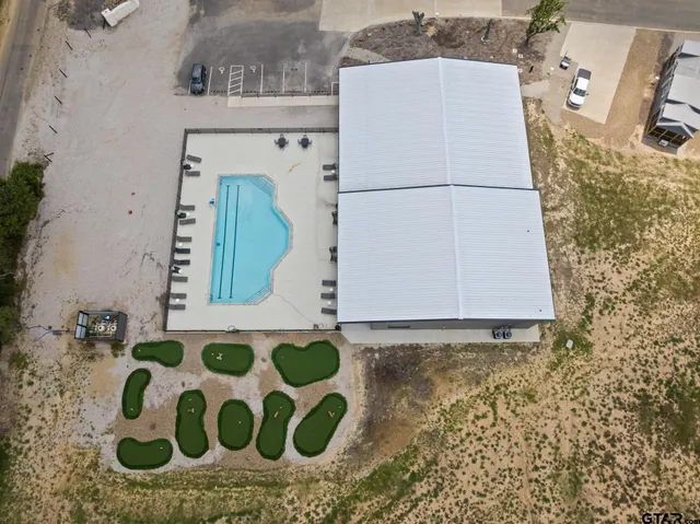 a view of a swimming pool with a lounge chairs