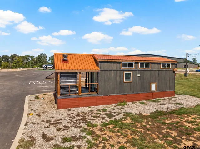 a backyard of a house with table and chairs