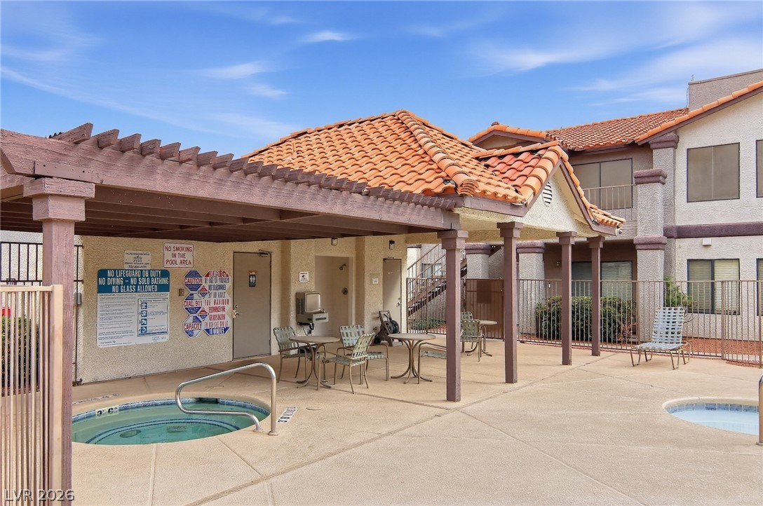 1575 West Warm Springs Road, Unit 2212 Henderson, NV 89014 - Photo 25 of 29 Clay tile roofing and a shaded pavilion overlook the inviting outdoor spa area.