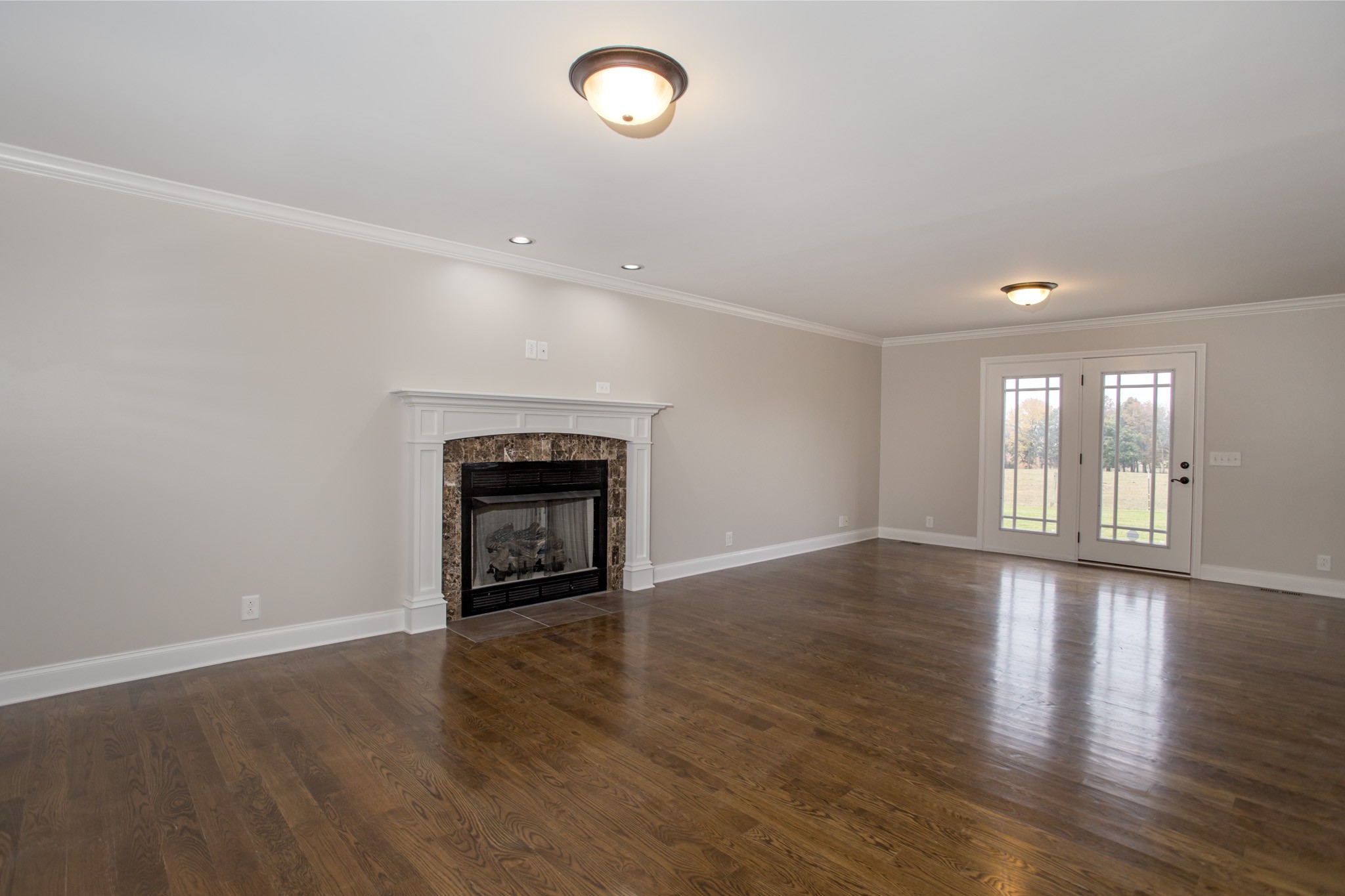 5325 Fred Perry Road Springfield, TN 37172 - Photo 3 of 26 an empty room with wooden floor and fireplace
