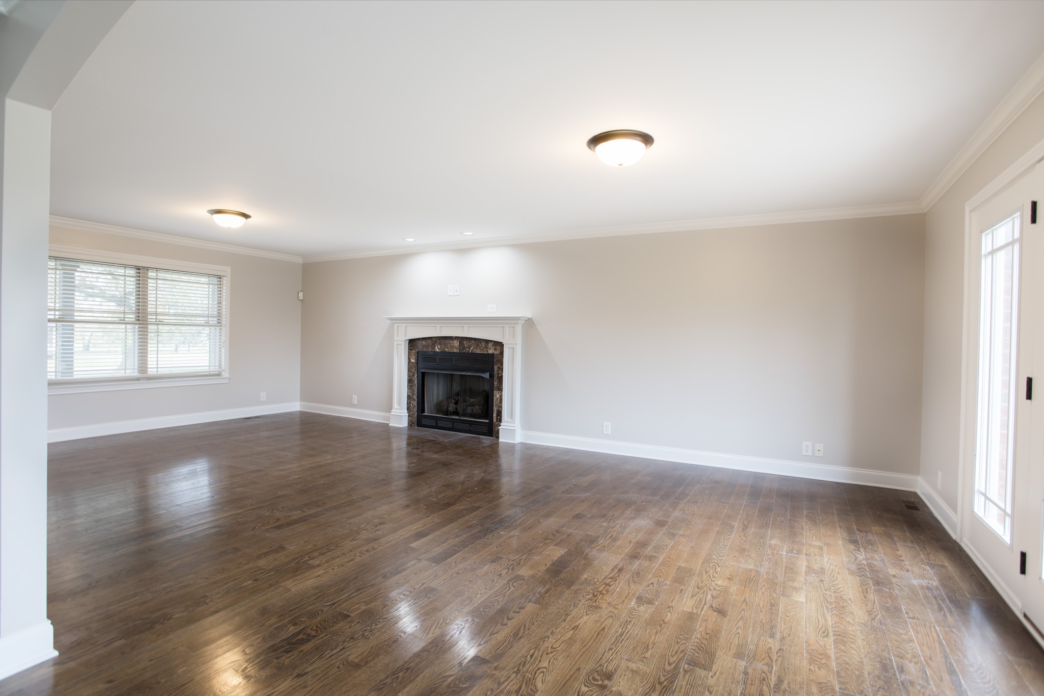 5325 Fred Perry Road Springfield, TN 37172 - Photo 4 of 26 an empty room with wooden floor and fireplace