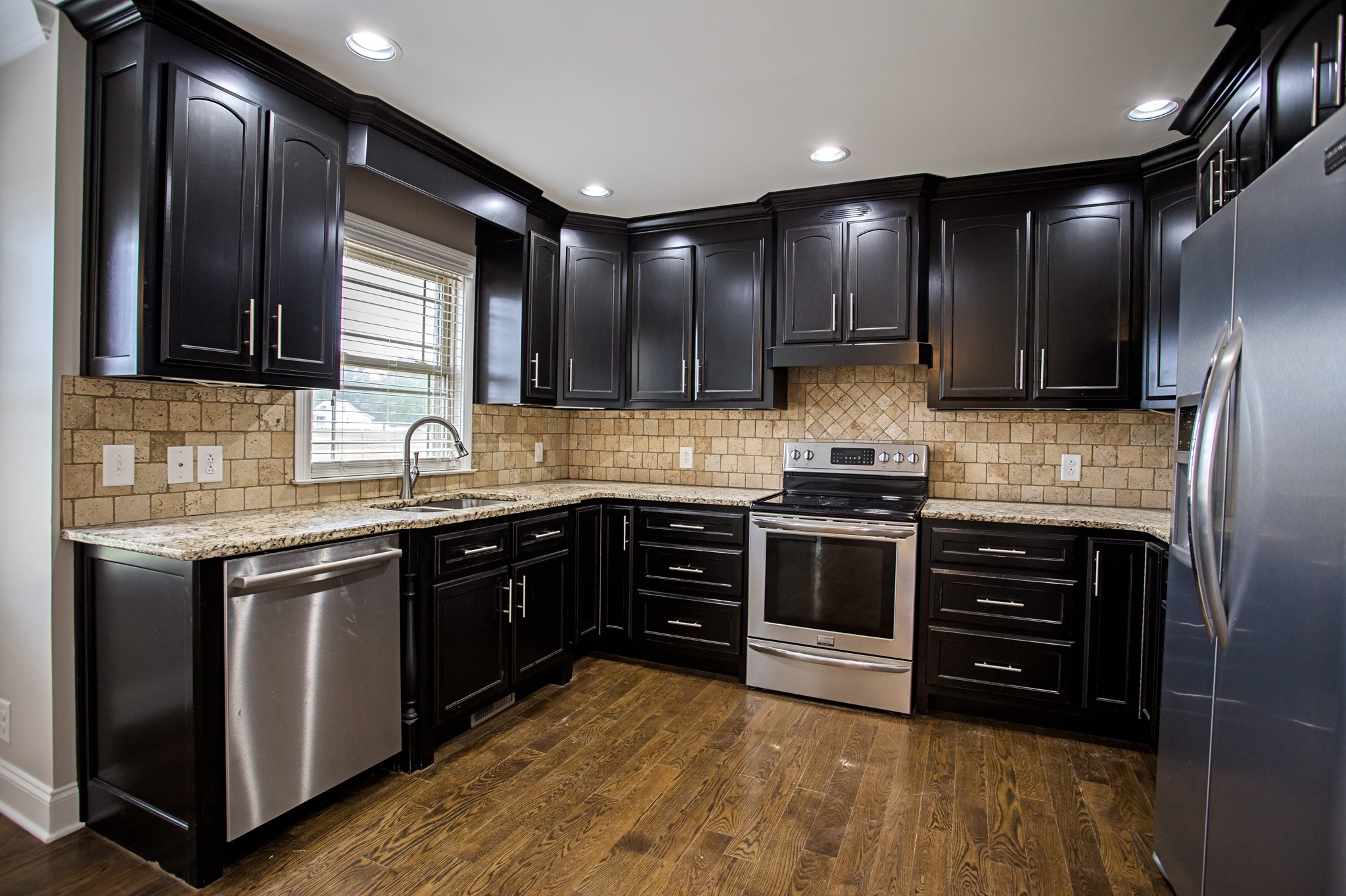 5325 Fred Perry Road Springfield, TN 37172 - Photo 6 of 26 a kitchen with stainless steel appliances granite countertop wooden cabinets and a stove top oven