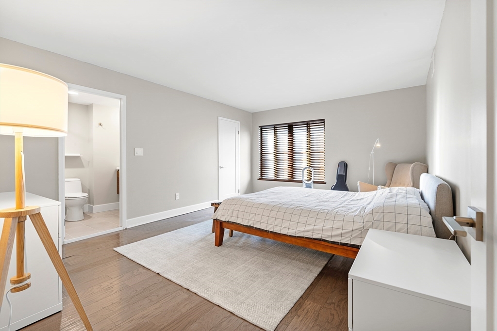 30 Stearns Road, Unit 201 Brookline, MA 02446 - Photo 11 of 29 a bedroom with a bed and wooden floor