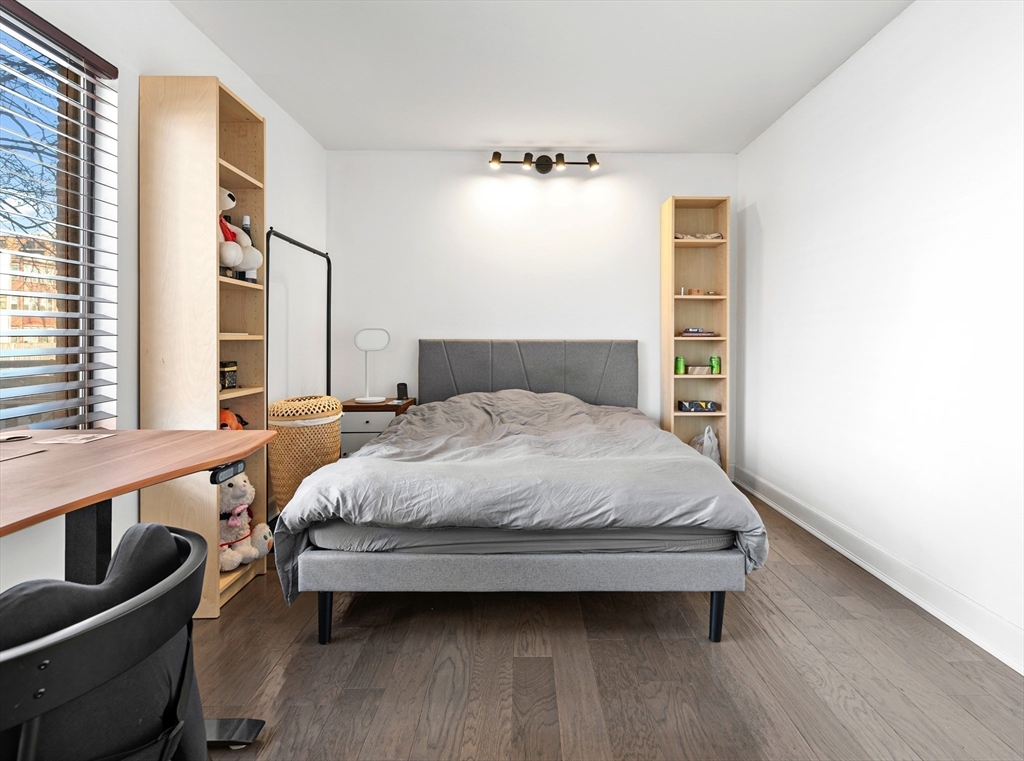 30 Stearns Road, Unit 201 Brookline, MA 02446 - Photo 18 of 29 a bedroom with a bed and wooden floor