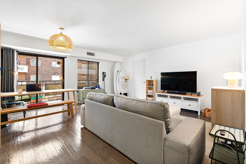 30 Stearns Road, Unit 201 Brookline, MA 02446 - Photo 2 of 29 a living room with furniture and a flat screen tv
