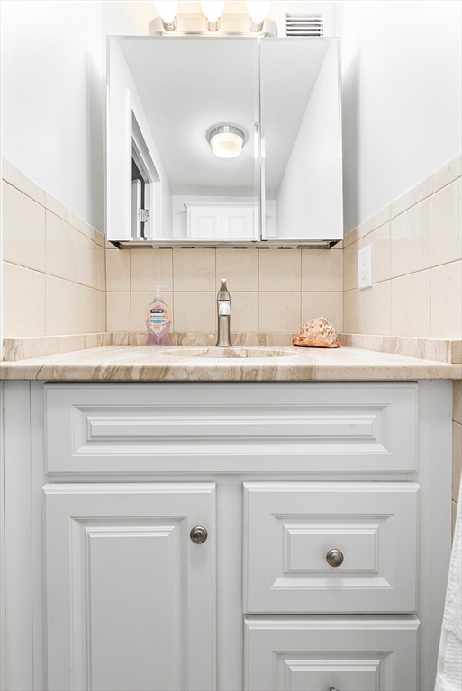 30 Stearns Road, Unit 201 Brookline, MA 02446 - Photo 23 of 29 a bathroom with a sink and a mirror