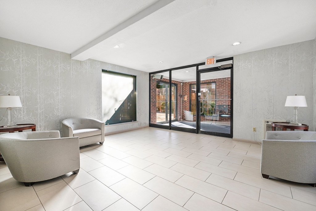 30 Stearns Road, Unit 201 Brookline, MA 02446 - Photo 24 of 29 a living room with furniture and a flat screen tv