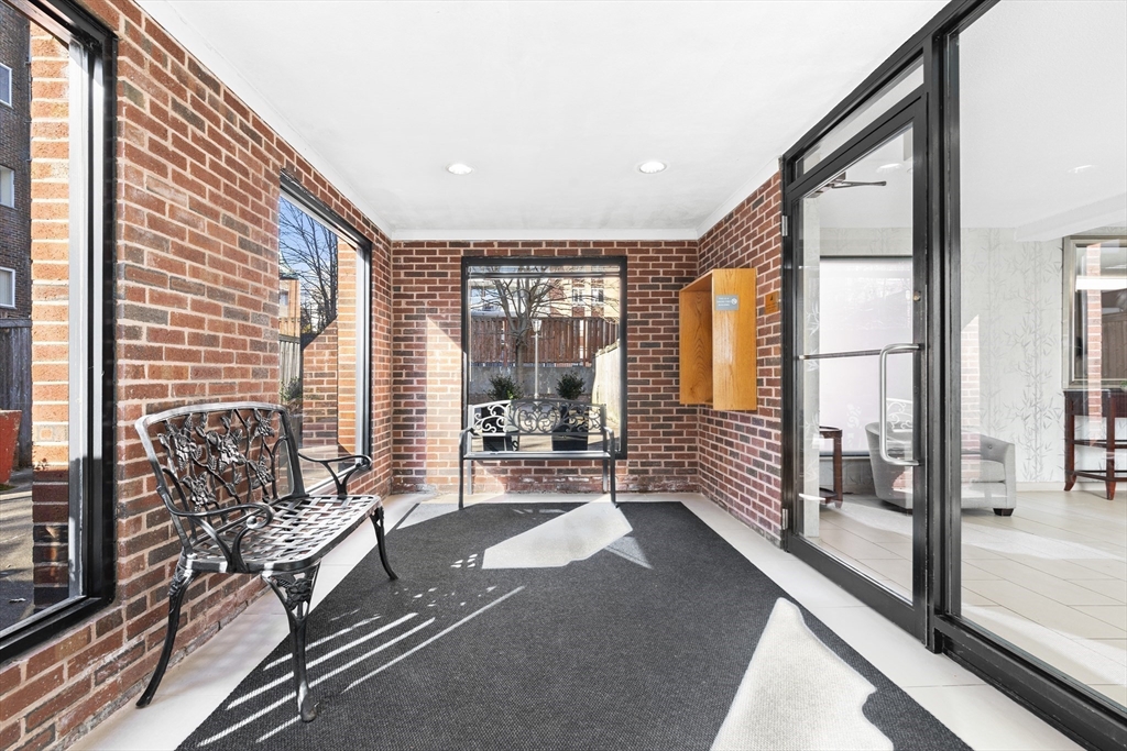 30 Stearns Road, Unit 201 Brookline, MA 02446 - Photo 26 of 29 a living room with furniture and a large window