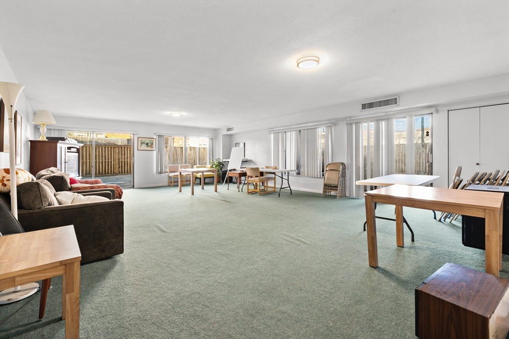 30 Stearns Road, Unit 201 Brookline, MA 02446 - Photo 28 of 29 a living room with furniture a window and a table