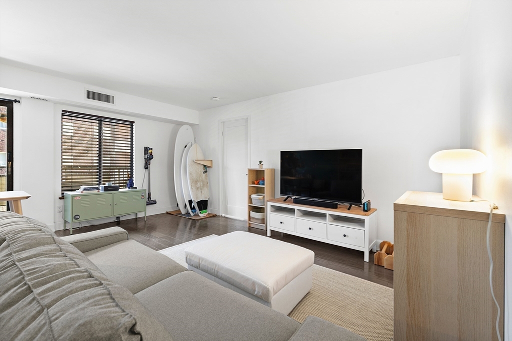 30 Stearns Road, Unit 201 Brookline, MA 02446 - Photo 3 of 29 a living room with furniture and a flat screen tv