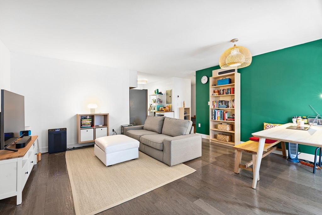 30 Stearns Road, Unit 201 Brookline, MA 02446 - Photo 4 of 29 a living room with furniture a rug and a chandelier
