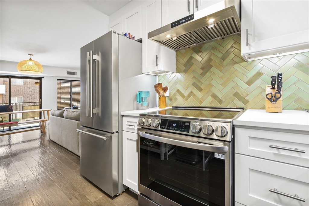 30 Stearns Road, Unit 201 Brookline, MA 02446 - Photo 7 of 29 a kitchen with granite countertop a stove and a refrigerator