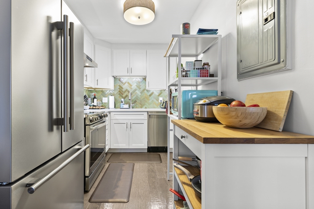 30 Stearns Road, Unit 201 Brookline, MA 02446 - Photo 9 of 29 a utility room with cabinets washer and dryer