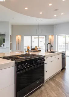 a kitchen with stainless steel appliances a stove a sink and a microwave