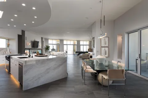 a living room with lots of furniture and kitchen view