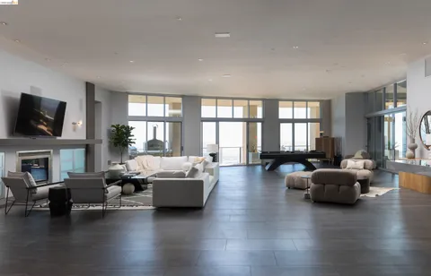 a living room with fireplace furniture and a large window