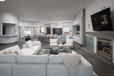 a living room with fireplace furniture and a flat screen tv