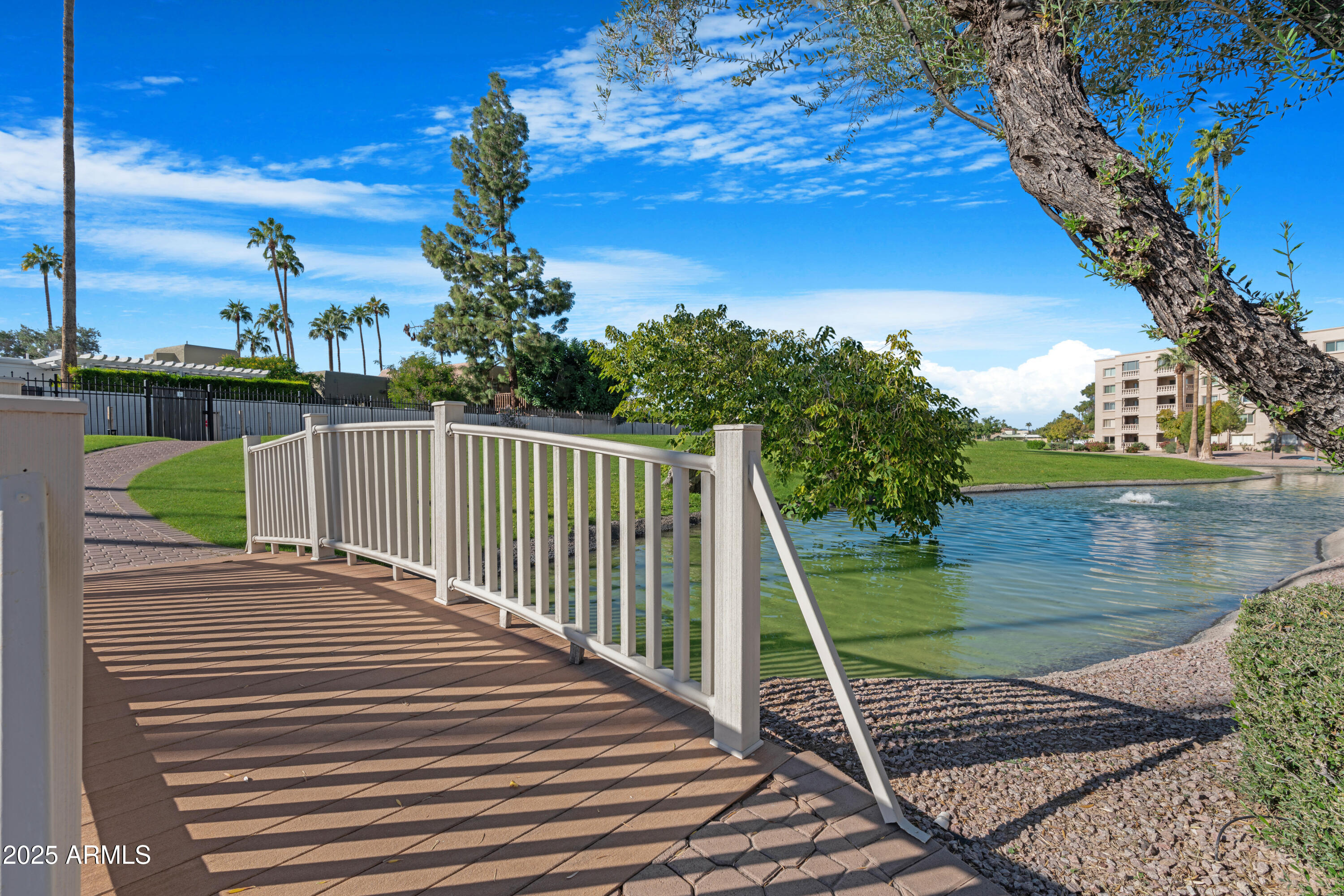 7820 East Camelback Road, Unit 510 Scottsdale, AZ 85251 - Photo 15 of 50 a view of a wooden deck with a lake
