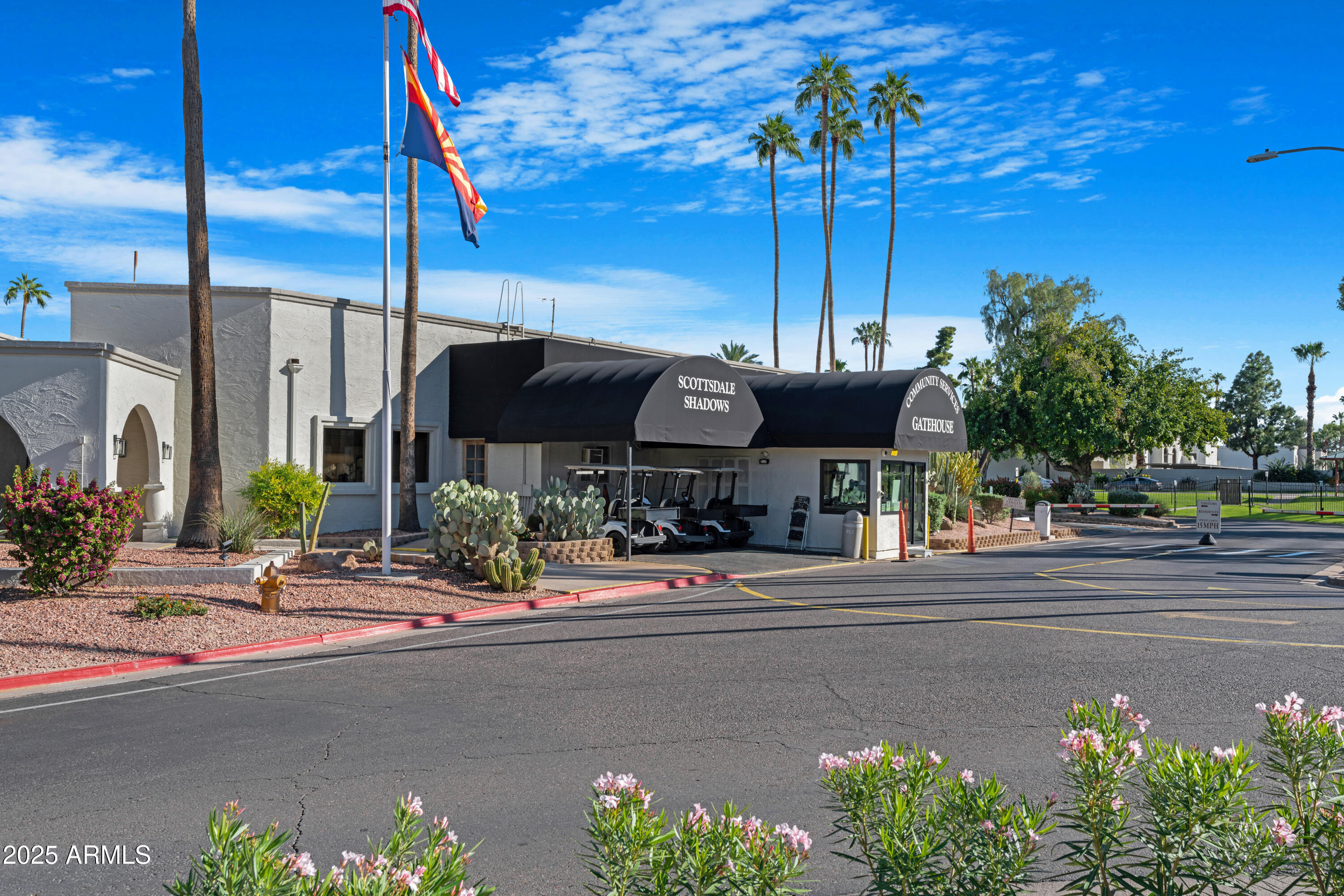 7820 East Camelback Road, Unit 510 Scottsdale, AZ 85251 - Photo 17 of 50 a front view of a house with a garden