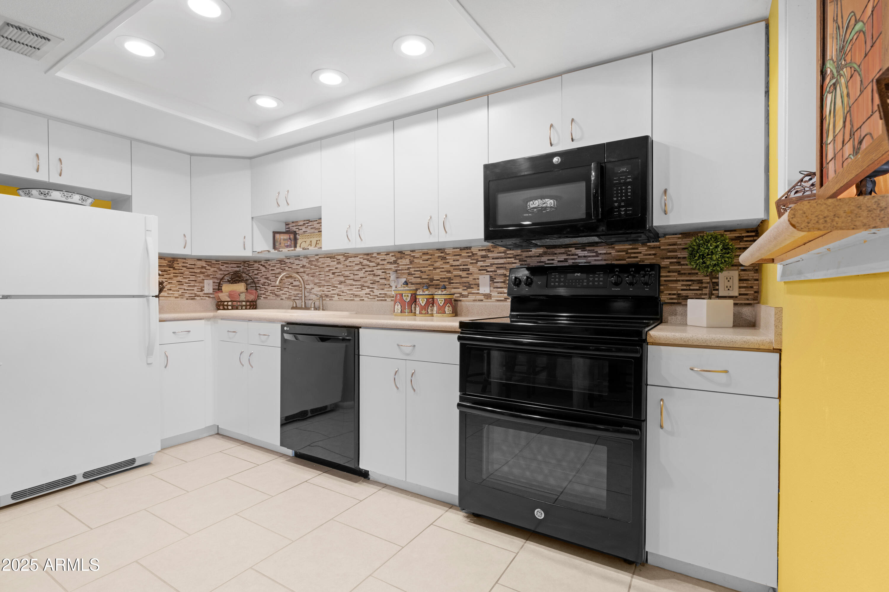7820 East Camelback Road, Unit 510 Scottsdale, AZ 85251 - Photo 34 of 50 a kitchen with a sink and a stove top oven
