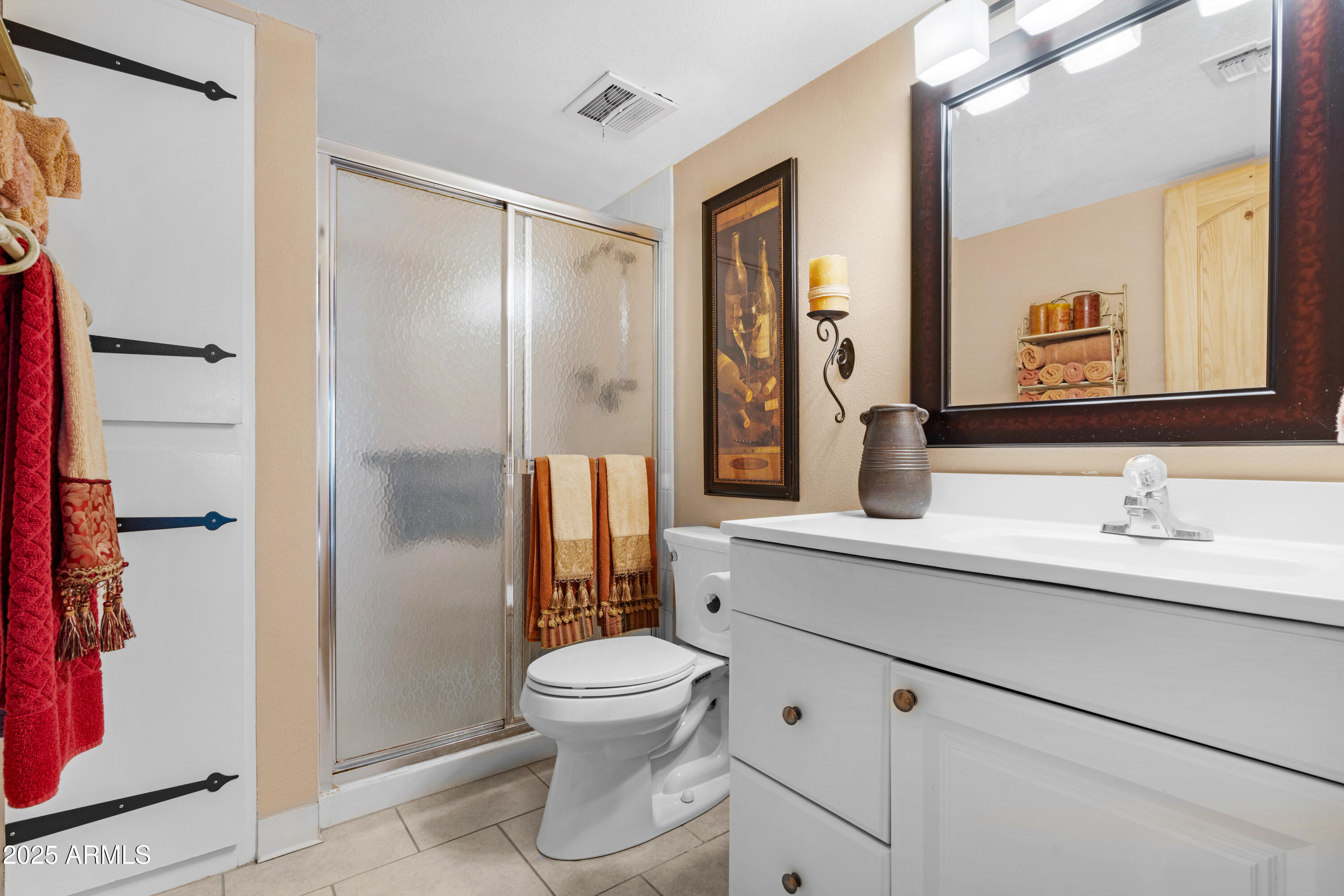 7820 East Camelback Road, Unit 510 Scottsdale, AZ 85251 - Photo 43 of 50 a bathroom with a toilet sink a mirror and shower