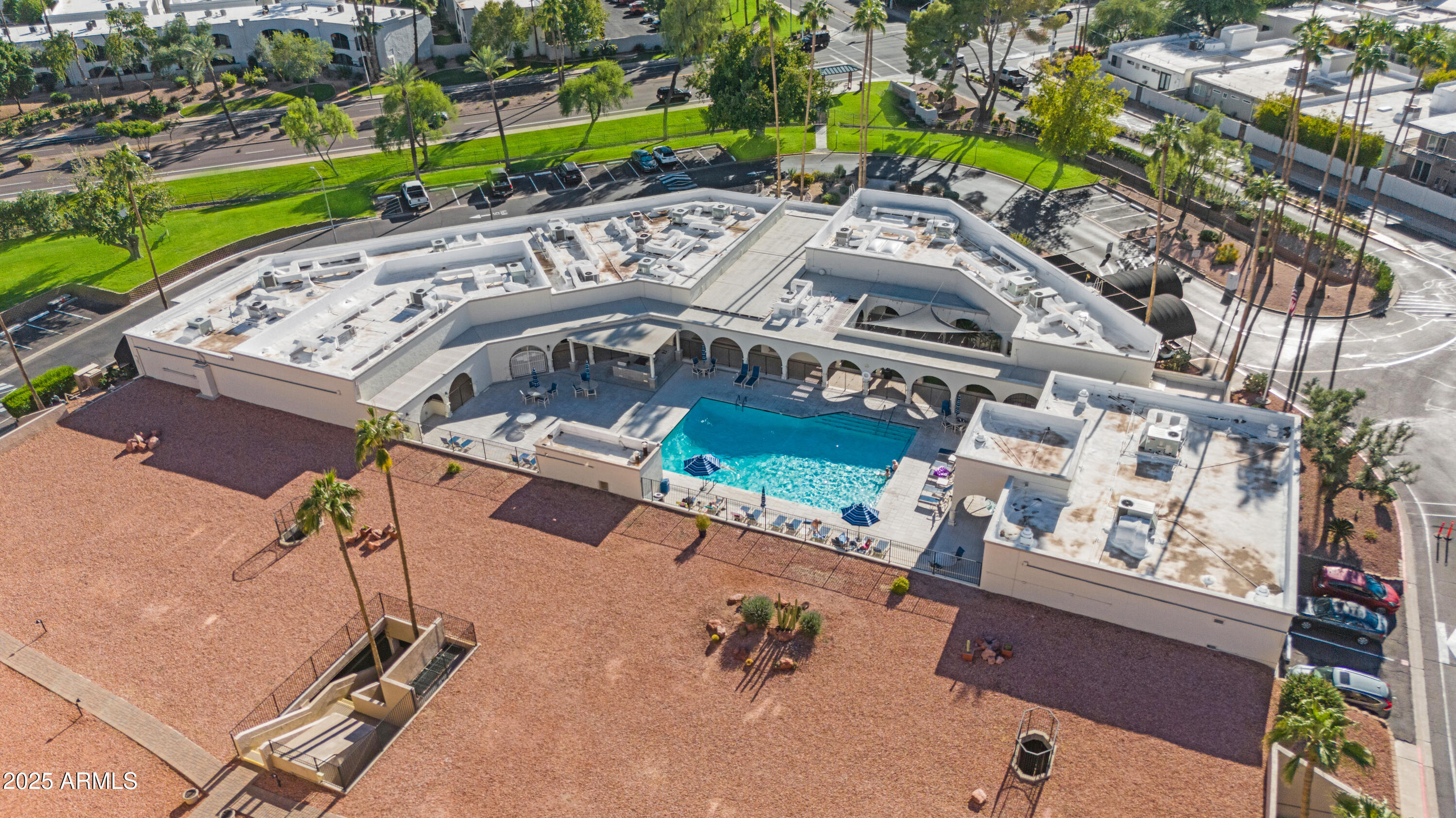 7820 East Camelback Road, Unit 510 Scottsdale, AZ 85251 - Photo 8 of 50 an aerial view of a swimming pool with a yard and outdoor seating
