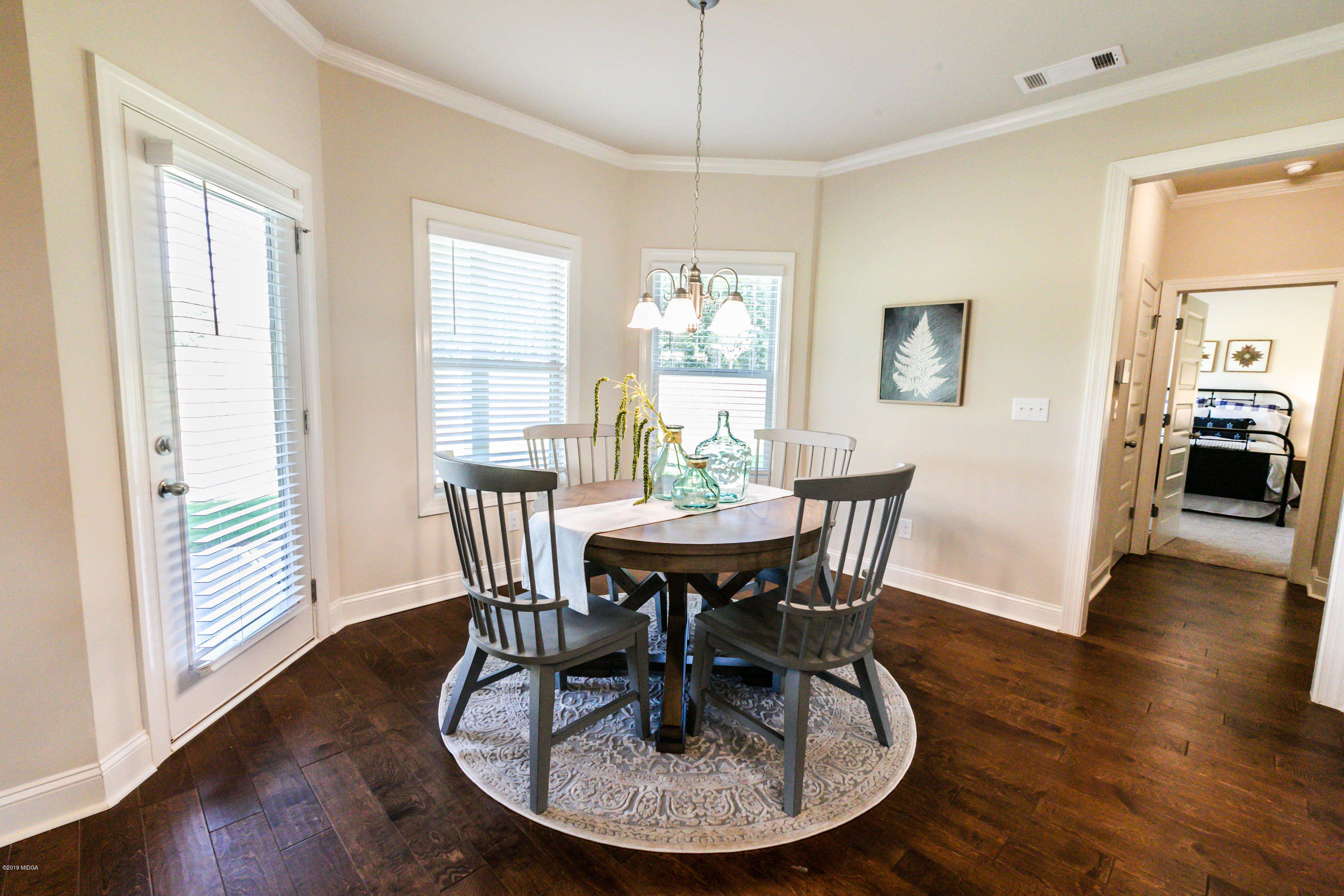 160 Homestead Circle Forsyth, GA 31029 - Photo 11 of 40 a view of a dining room with furniture window and wooden floor