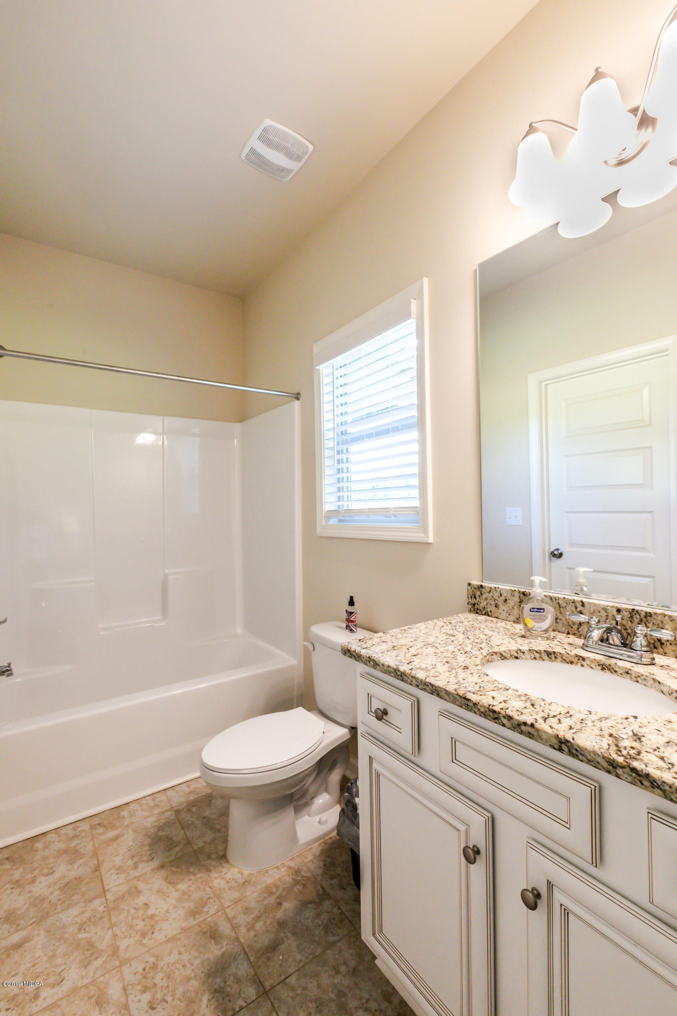 160 Homestead Circle Forsyth, GA 31029 - Photo 15 of 40 a bathroom with a granite countertop sink a toilet and shower